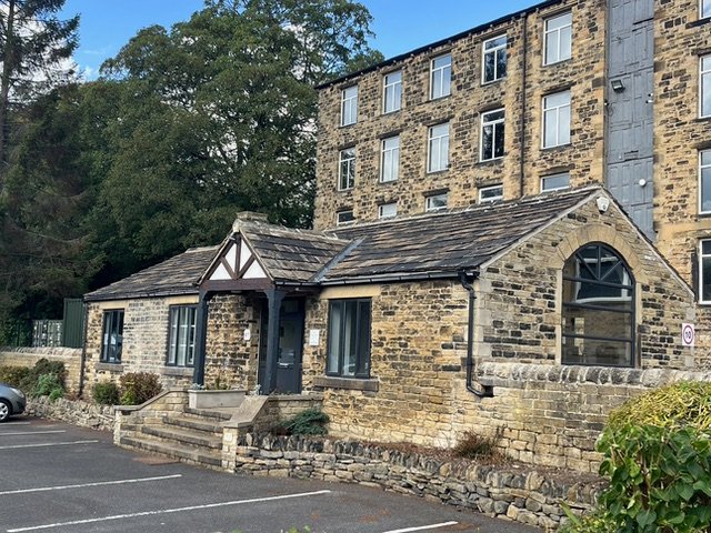 A&P Coffee Quarters - stone cottage building with parking spaces in front